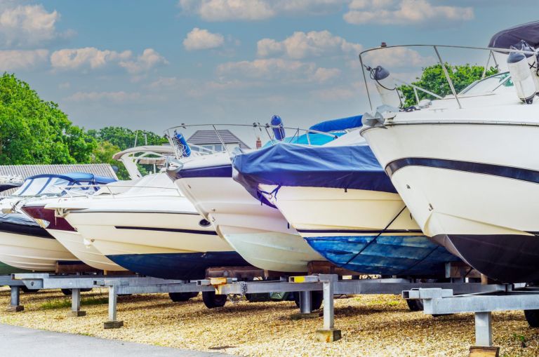 Boat on stand on the shore, close up on the part of the yacht, luxury ship, maintenance and parking place boat, marine industrial